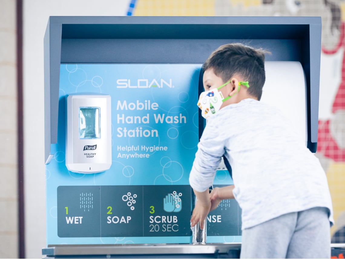 Child using mobile handwashing station